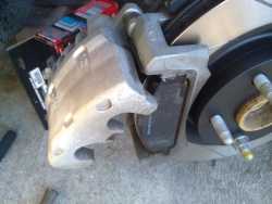 Brake Caliper partially fitted using 1 bolt to assist in caliper piston compression