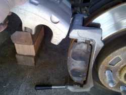 Swinging the Caliper Upwards to access the Brake Pads